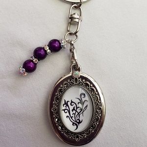 Oval-shaped Younique Keychain